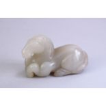 A GOOD CHINESE CARTVED JADE FIGURE OF A RECUMBENT HORSE, 7CM