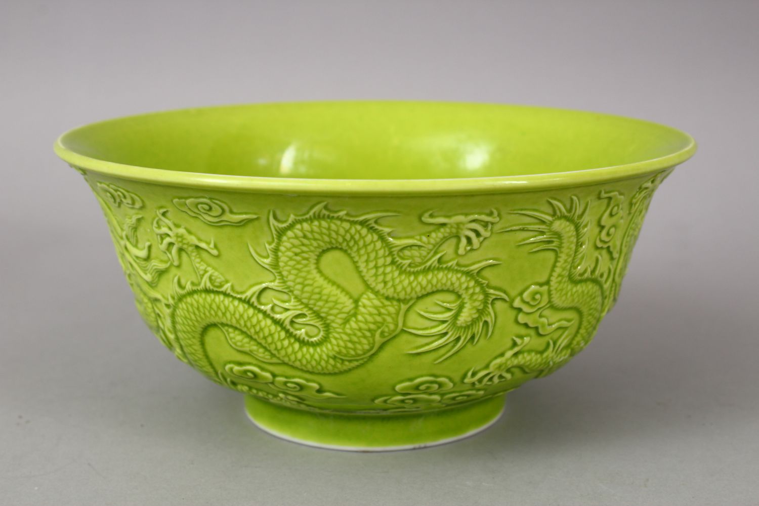 A CHINESE GREEN GLAZED PORCELAIN DRAGON BOWL, with moulded decoration of dragons amongst stylized - Image 2 of 6