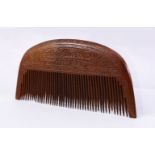 A 19TH CENTURY PERSIAN WOOD COMB CARVED WITH CALLIGRAPHY, 17cm wide.