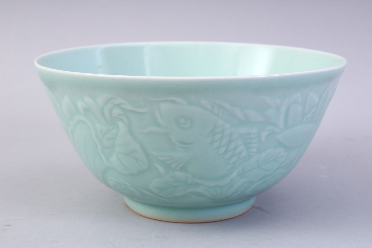 A CHINESE CELADON MOULDED PORCELAIN CARP BOWL, the bowl with carved decoration of fish and lotus, - Image 4 of 8