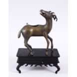 A GOOD CHINESE BRONZE CENSOR OF A DEER, stood upon a fixed carved wooden base, the deer with its