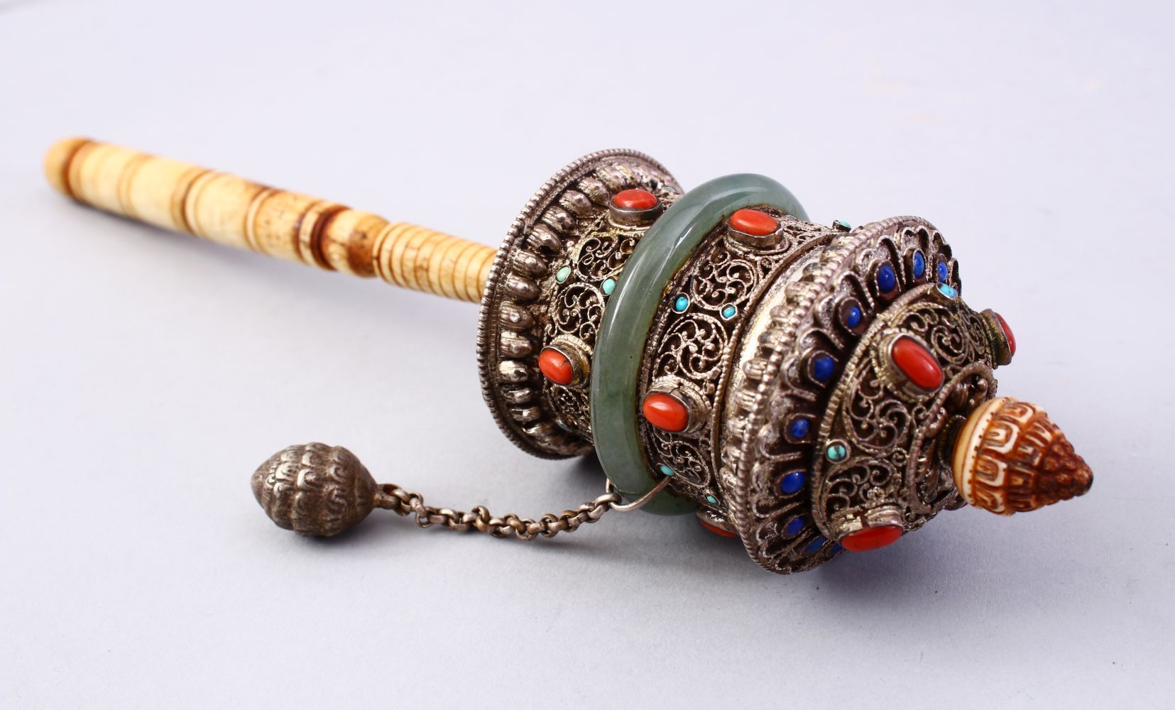 A GOOD 19TH CENTURY TIBETAN WHITE METAL AND INLAID PRAYER WHEEL, the wheel with filigree style metal