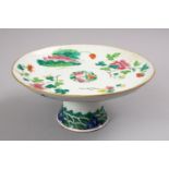 A 19TH CENTURY CHINESE FAMILLE ROSE PORCELAIN STEM DISH, decorated with native array of flora with a