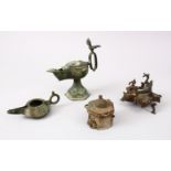 A COLLECTION OF FOUR INDIAN & PERSIAN OIL LAMPS AND A 12TH CENTURY INKWELL (4)