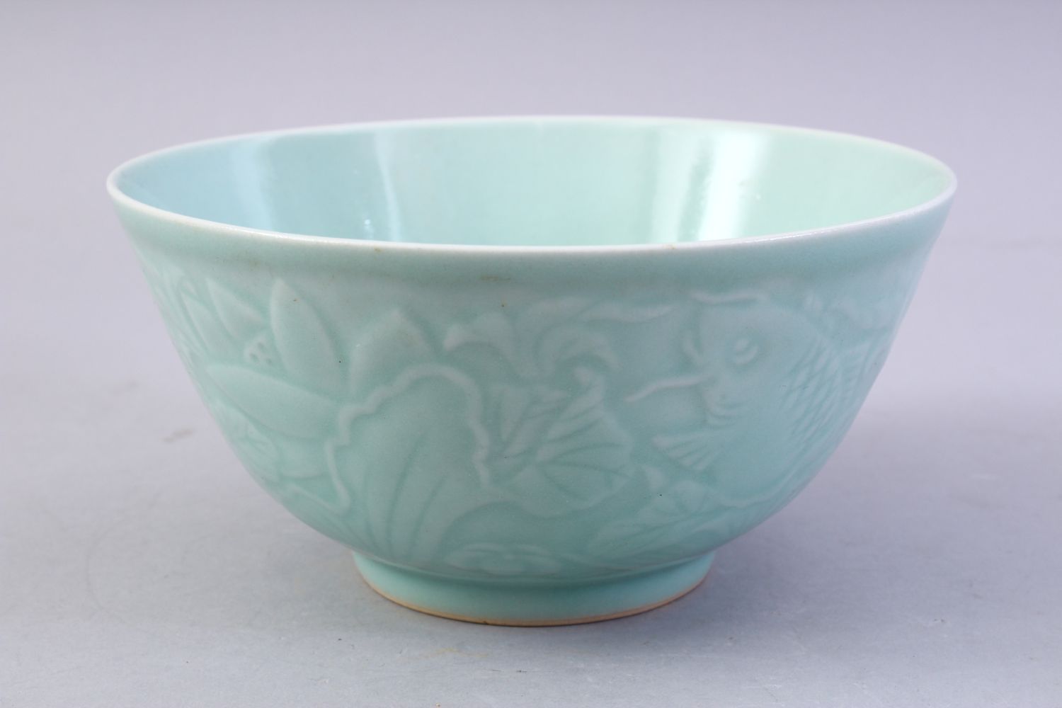 A CHINESE CELADON MOULDED PORCELAIN CARP BOWL, the bowl with carved decoration of fish and lotus, - Image 3 of 8