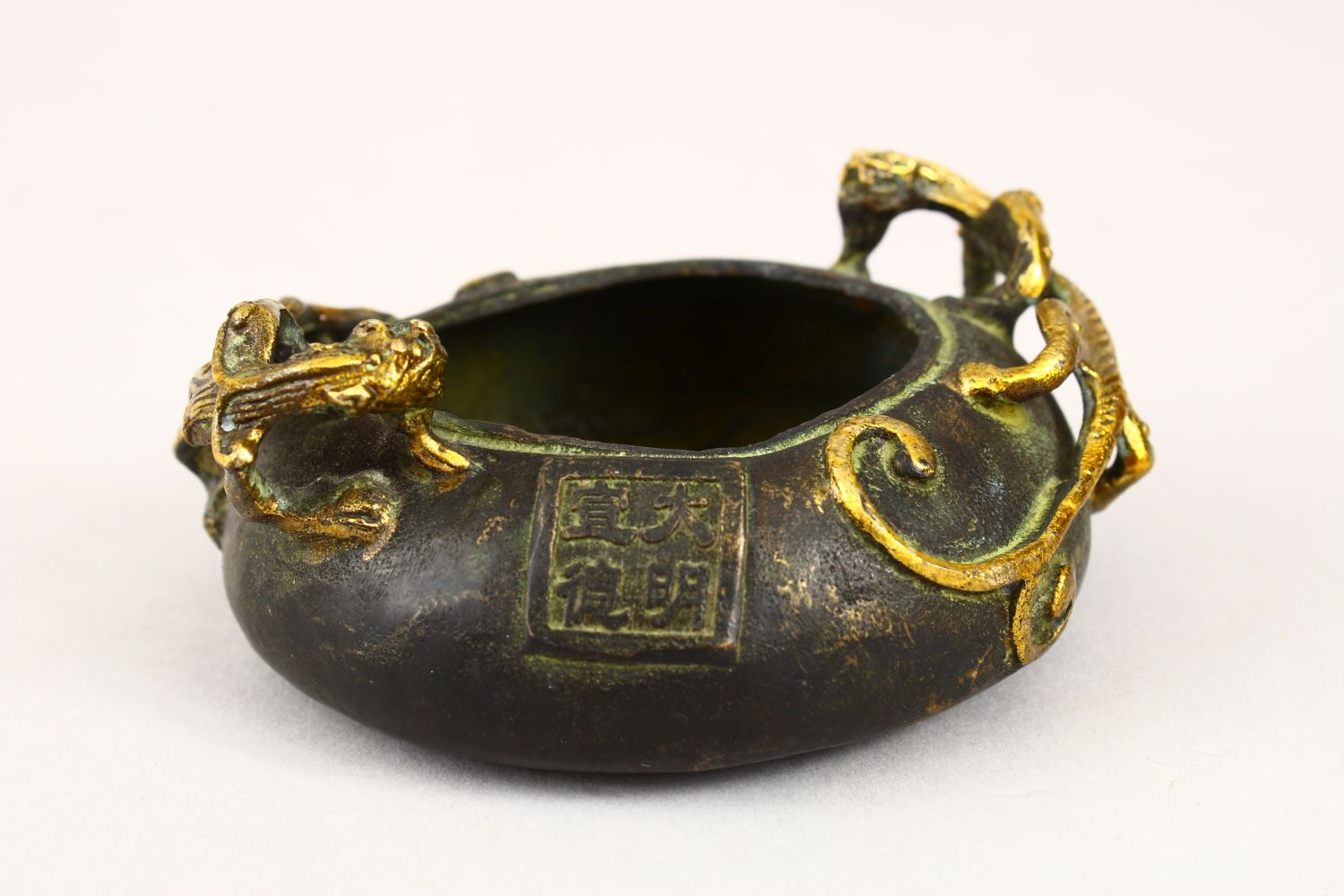 A 20TH CENTURY CHINESE BRONZE TWIN HANDLE CENSER, the censer with moulded gilded handles in the form - Image 3 of 5