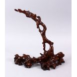 A GOOD CHINESE CARVED HARDWOOD NATURALISTIC ARCHED STAND, 26cm high x 24cm wide.