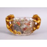 A CHINESE PEKING GLASS TWIN HANDLE LIBATION CUP, with painted decoration of birds and floral display