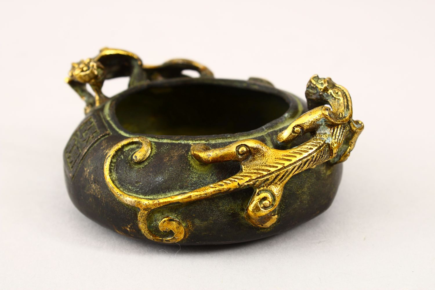 A 20TH CENTURY CHINESE BRONZE TWIN HANDLE CENSER, the censer with moulded gilded handles in the form - Image 2 of 5