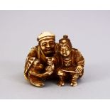 A JAPANESE MEIJI PERIOD CARVED IVORY OKIMONO - MAN & MONKEY, the seated monkey keeper seated aside