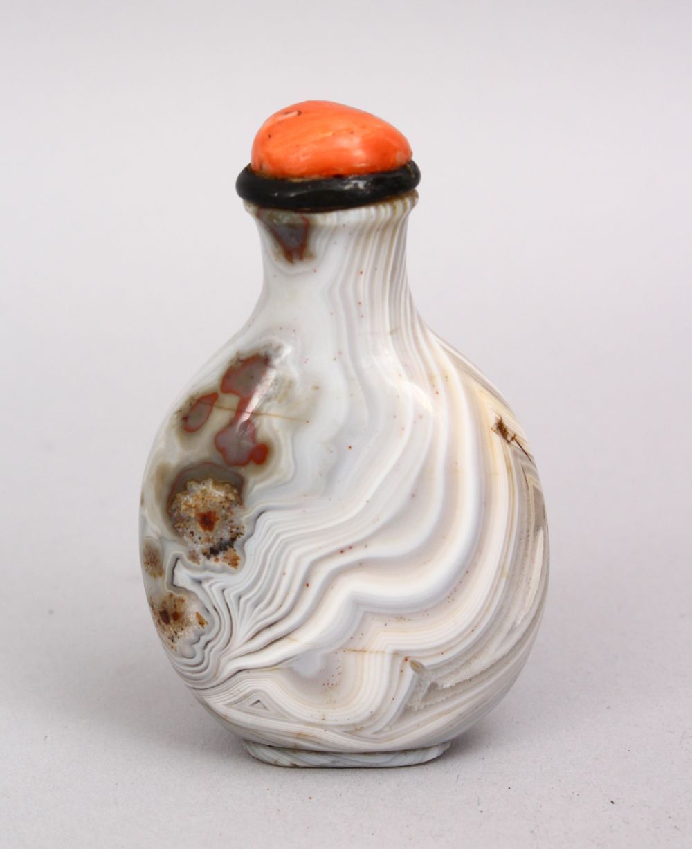 A FINE 19TH / 20TH CENTURY CHINESE CARVED AGATE SNUFF BOTTLE, with a coral stopper, 8cm.