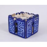 A GOOD EARLY PERSIAN POTTERY INKWELL, with cobalt blue ground with floral decoration, 6.5cm square.
