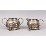 TWO 19TH CENTURY INDIAN CALCUTTA SILVER TEA SET ITEMS, sugar bowl and cream jug, with embossed