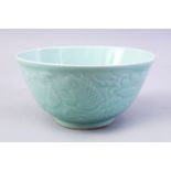 A CHINESE CELADON MOULDED PORCELAIN CARP BOWL, the bowl with carved decoration of fish and lotus,