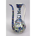 A 19TH CENTURY PERSIAN QAJAR GLAZED POTTERY EWER, with floral decoration, 28.5cm.