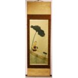 A GOOD CHINESE 19TH / 20TH CENTURY HANGING SCROLL PAINTING OF A CHILD SEATED AMONGST LOTUS GROWTH,