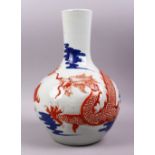 A LARGE 19TH / 20TH CENTURY CHINESE IRON RED & UNDERGLAZE BLUE DRAGON PORCELAIN BOTTLE VASE, with an