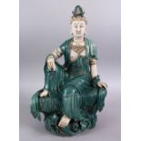 A LARGE CHINESE TURQUOISE GLAZED PORCELAIN FIGURE OF GUANYIN, in a seated position upon lotus,