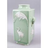 A GOOD CHINESE CELADON TWIN HANDLE SQUARE FORMED PORCELAIN CRANE VASE, the body with carved