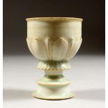 A GOOD CHINESE YUAN STYLE HUTIAN WARE WINE CUP, the body with moulded decoration, 9cm high x 6.7cm.