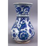 A GOOD PERSIAN 19TH CENTURY BLUE & GREEN DECORATED POTTERY VASE, with formal scrolling flora, and
