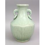 A GOOD CHINESE CELADON MOULDED PORCELAIN TWIN HANDLE VASE, the body of octagonal form with carved