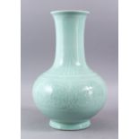 A CHINESE CELADON PORCELAIN MOULDED VASE, the body with archaic style chilong carved decoration, the