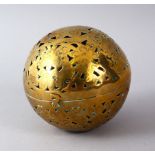 A 19TH CENTURY INDIAN BRASS HAND WARMER, with open work, 10cm diameter.