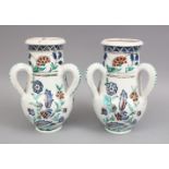 A PAIR OF IZNIK STYLE POSS EUROPEAN POTTERY TRIPLE HANDLED VASES, each vase with three moulded