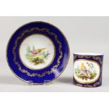 A GOOD SEVRES CUP AND SAUCER, rich blue ground painted with birds. Mark in blue, No, 2.