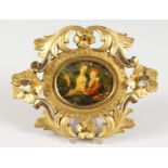 AN 18TH CENTURY ITALIAN MINIATURE IN A CARVED AND GILDED FRAME.