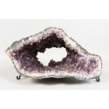 A LARGE AMETHYST GEODE on a wrought metal base. 15ins.