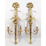 A GOOD PAIR OF CARVED AND GILDED WALL APPLIQUES, 20TH CENTURY, each with a pair of scrolling
