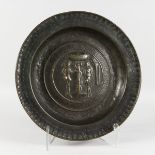 A 16TH CENTURY GERMAN BRASS ALMS DISH, with embossed decoration depicting Adam and Eve beside the