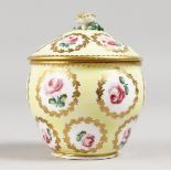 A SMALL SEVRES PALE YELLOW GROUND BOWL AND COVER painted with roses. 3.5ins high.