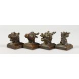 A SET OF FOUR CHINESE BRONZE ANIMAL HEAD SEALS depicting animals of the zodiac. 1.5ins high.