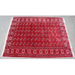 A GOOD LARGE MODERN BOKHARA CARPET, claret ground with six rows of fourteen gulls. 12ft 10ins x