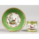 A GOOD SEVRES CUP AND SAUCER, green ground painted with birds. Mark in blue, Letters GG.