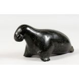 AN INUIT CARVED HARDSTONE GROUP OF A SEAL. Etched on base E.S. 1749. 6ins long.