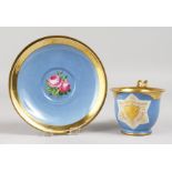 A GOOD VIENNA CUP AND SAUCER, blue ground edged in gilt, crest and flowers. Beehive mark in blue.
