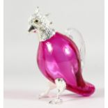 A PARROT SHAPED CLARET JUG, with plated head and feet, cranberry colour glass body. 6ins high.