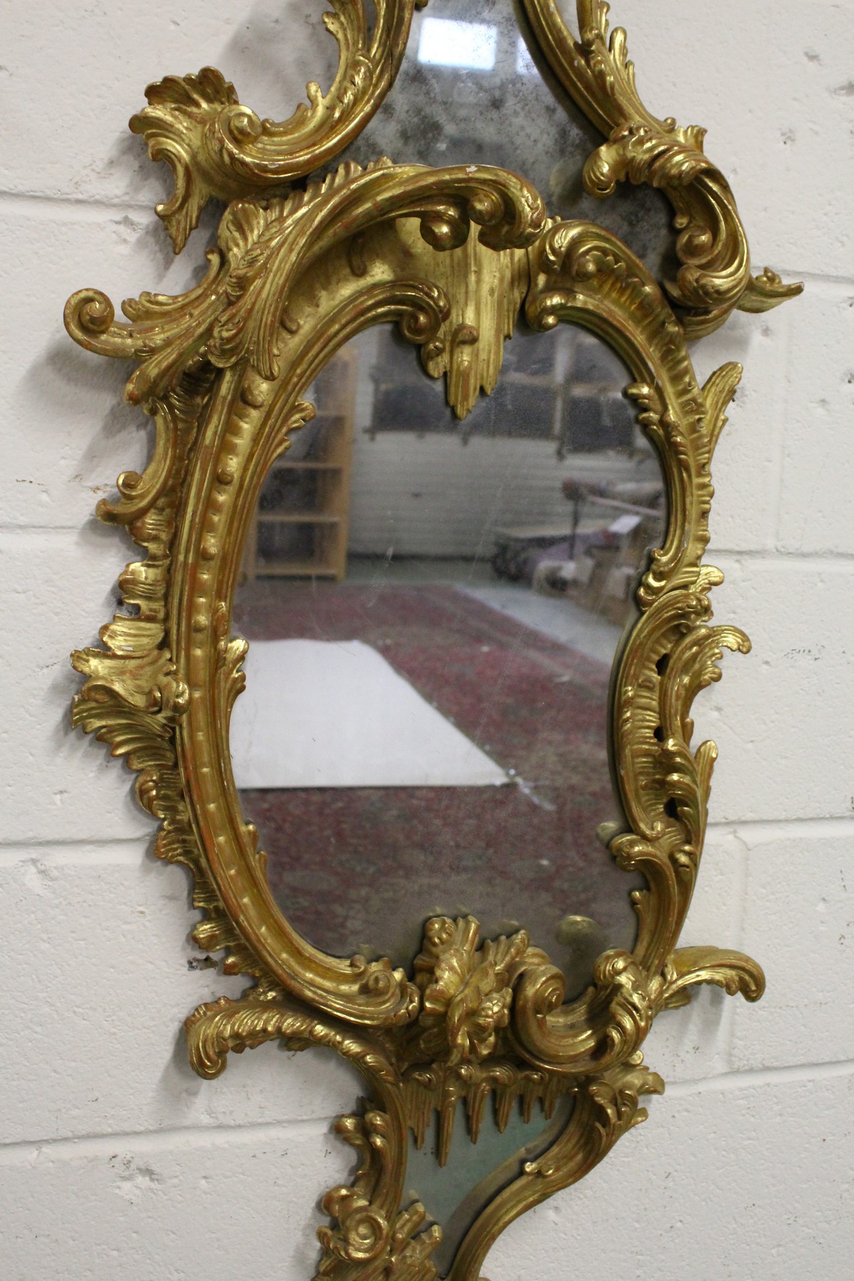 A GOOD CHIPPENDALE CARVED AND GILDED ROCOCO DESIGN MIRROR with scrolls and foliage. 4ft 10ins high x - Image 3 of 4