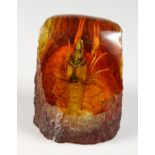 AN AMBER STYLE PAPERWEIGHT INSET WITH A CRAYFISH. 3.5ins high.