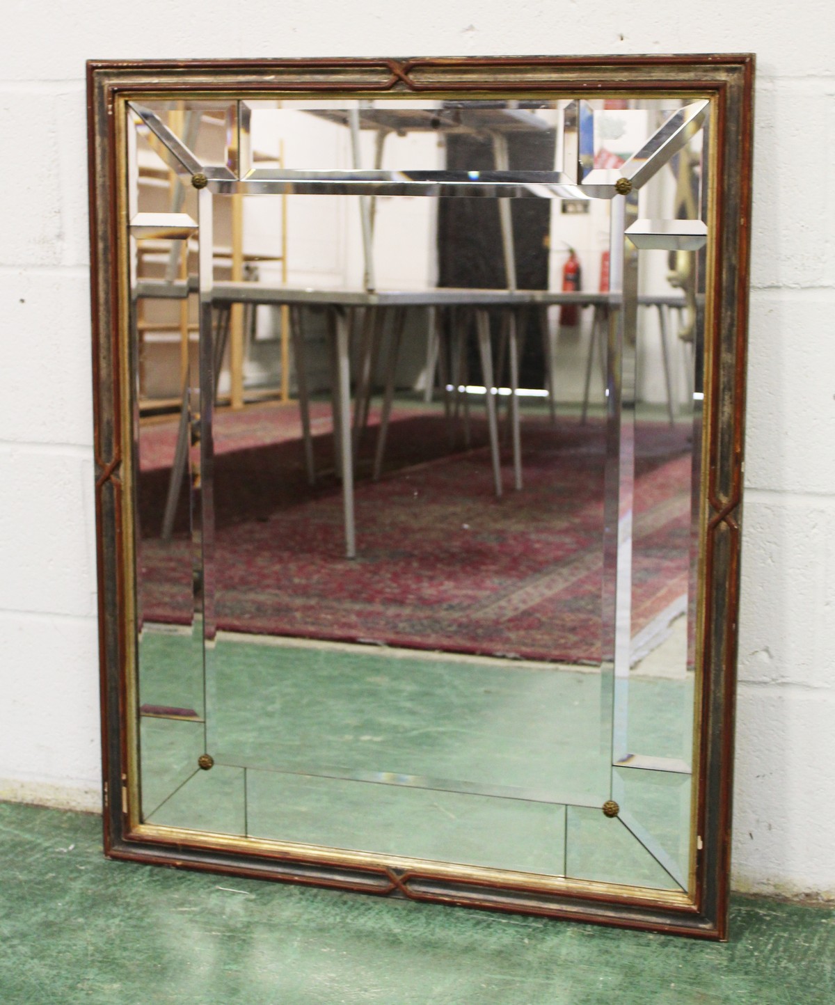 A DECORATIVE WALL MIRROR, with bevelled mirror plates. 3ft 2.5ins x 2ft 4.5ins.