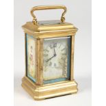 A MINIATURE BRASS CARRIAGE CLOCK, with Sevres style porcelain panels. 3ins high.