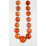 A FACETED CARNELIAN BEAD NECKLACE.