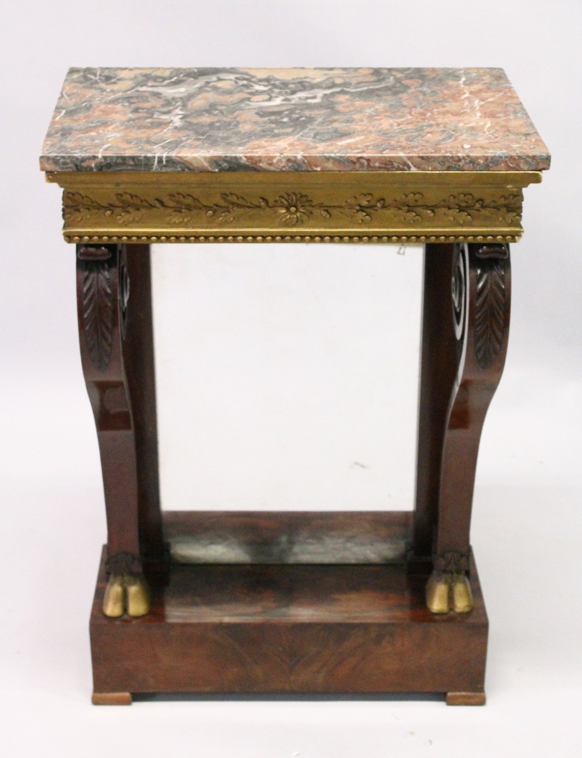 A REGENCY MAHOGANY SMALL PIER/CONSOLE TABLE, with a marble top over an ornate gilded frieze, on a