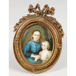 A 19TH CENTURY FRENCH OVAL PORTRAIT MINIATURE OF A MOTHER AND CHILD, in an ormolu easel frame.
