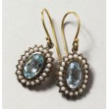 A PAIR OF 9CT GOLD AND SILVER, BLUE TOPAZ AND PEARL EARRINGS.