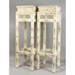 AN UNUSUAL PAIR OF CHINESE BONE PEDESTAL STANDS, with carved and pierced decoration. 41.5ins high